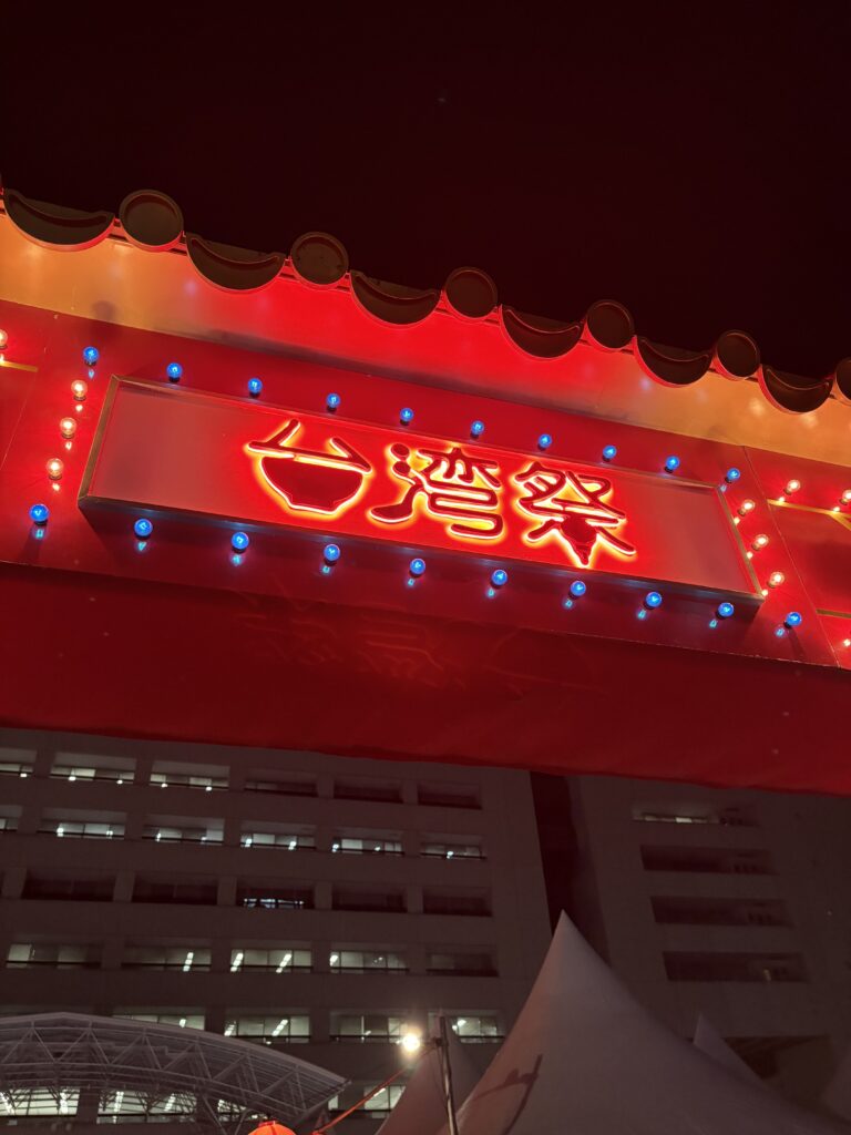 台湾祭 in 福岡2025のメインゲート。真っ赤なネオンが夜空に輝くフォトスポット